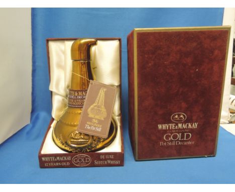 A Whyte & Mackay 12 year old deluxe Scotch whisky in 22carat glazed pot still decanter, in original box