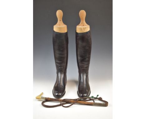Pair of vintage riding boots with trees and a riding whip, approximately size 10