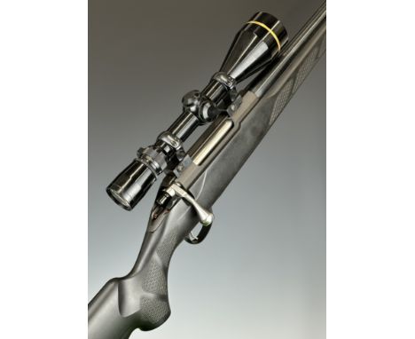 Tikka T3 .243 Winchester bolt-action rifle with composite stock, textured semi-pistol grip and forend, neoprene sling, Leupol