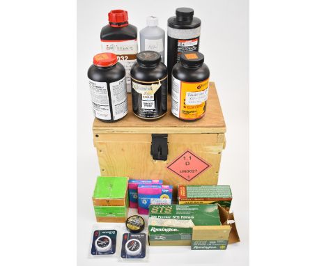 A collection of shotgun or rifle cartridge re-loading materials including six tubs of smokeless powder, percussion caps, prim