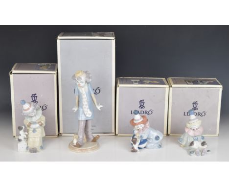 Seven Lladro clown figures with puppies, saxophone etc, all boxed, tallest 23cm