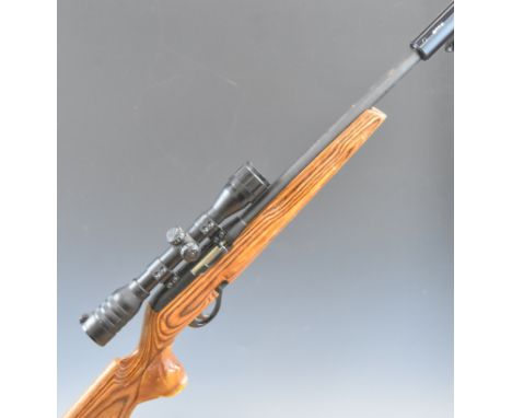 Remington Model 597 .22 semi-automatic rifle with laminated show wood stock, semi-pistol grip, adjustable butt plate, Kassnar