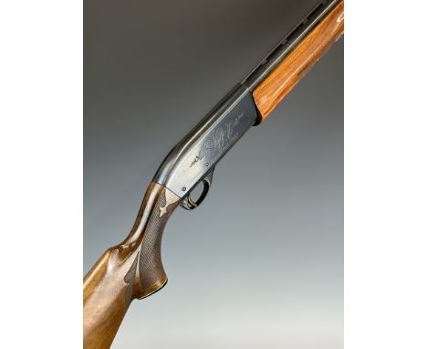 Remington Model 1100 LH 12 bore 3-shot semi-automatic shotgun with ornately carved and chequered semi-pistol grip and forend,