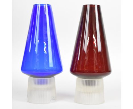 Two Per Lutken for Holmegaard Hygge tea light holders / lamps, one red and one blue, both with clear bases, 26cm tall.&nbsp;