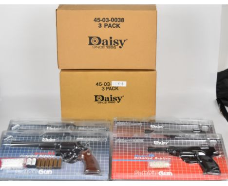 Six Daisy Model 57 airsoft revolvers and Model 38 airsoft pistols, all sealed in original packaging.
