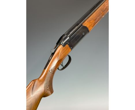 Valmet 12 bore over and under shotgun with engraved locks and underside, chequered semi-pistol grip and forend, single trigge