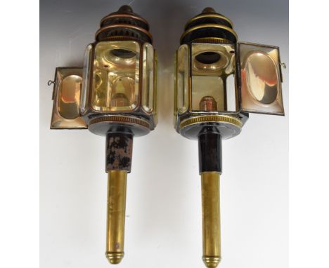 A pair of Victorian brass and black lacquer carriage lantern lamps with bevelled glass windows by Morgan & Co of London, H56c