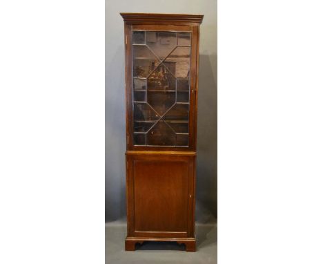 A Mahogany Bookcase, the moulded cornice above an astragal glazed door enclosing shelves, the lower section with a panel door