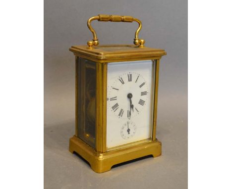 A French Brass Cased Carriage Clock, the enamel dial with Roman numerals and subsidiary alarms dial and with lever escapement