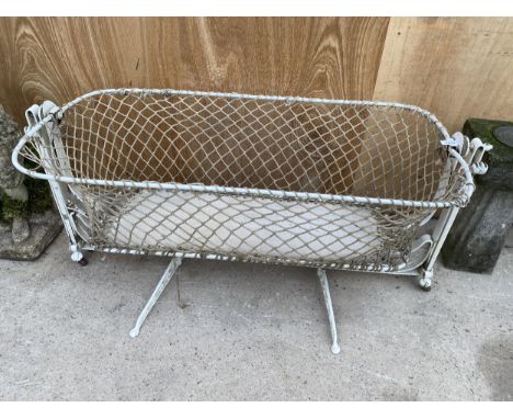A VINTAGE METAL SWINGING CHILDS CRIB WITH ROPE SIDES 