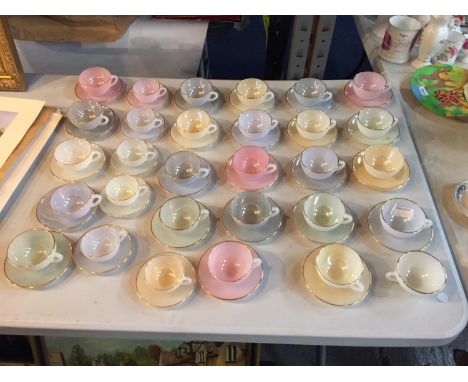 A LARGE COLLECTION OF ARCOPAL OPALESCENT TEACUPS AND SAUCERS IN BOTH LARGE AND SMALL SIZES 