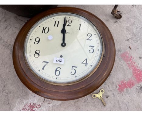 A WOODEN CASED CIRCULAR WALL CLOCK 