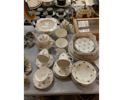 A LARGE AMOUNT OF CHINA DINNERWARE TO INCLUDE CUPS, SAUCERS, PLATES, TEAPOTS, BOWLS, ETC 