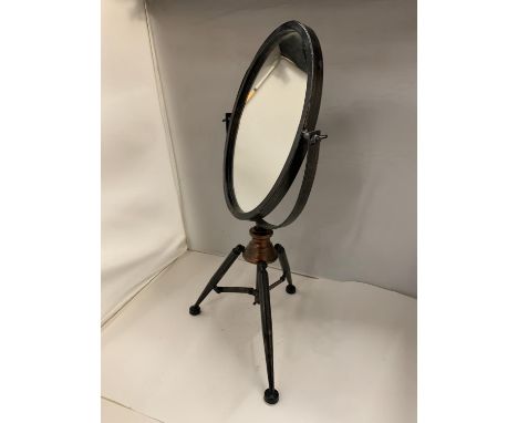 A VANITY MIRROR ON A METAL TRIPOD STAND 