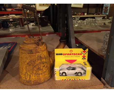 AN AC WELLS UNBREAKABLE CAST IRON KETTLE OIL LAMP AND A DIE CAST CAR 