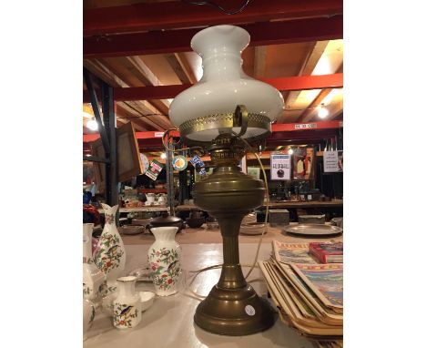 A BRASS AND GLASS OIL LAMP CONVERTED TO A TABLE LAMP 