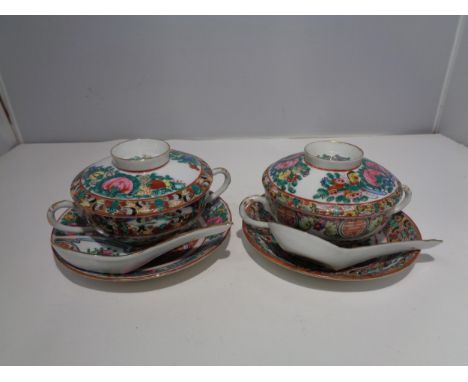 A PAIR OF ORIENTAL LIDDED BOWLS AND SAUCERS WITH SPOONS 