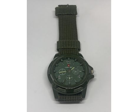 A SWISS ARMY WRISTWATCH WITH GREEN CANVAS STRAP SEEN WORKING BUT NO WARRANTY 