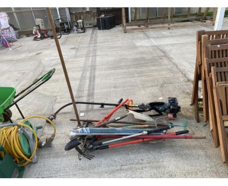 AN ASSORTMENT OF GARDEN TOOLS TO INCLUDE FORKS, SPADES AND A PETROL GRASS STRIMMER ETC 