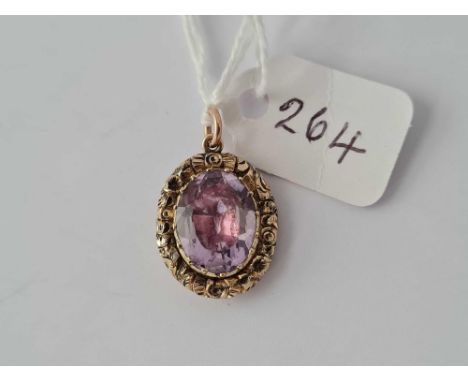 A very fine Georgian amethyst pendant with foliate frame decoration set in high carat