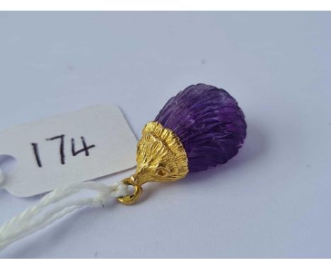 A gold and amethyst hedgehog charm 9ct
