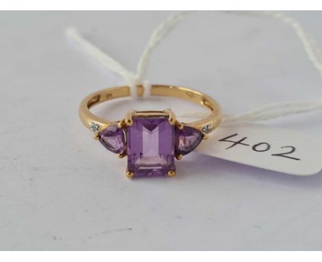 A amethyst set dress ring with large central stone 9ct size P