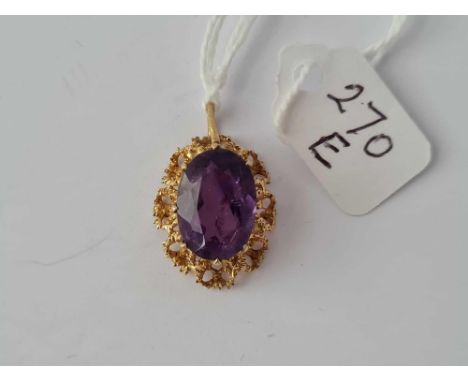 A large amethyst fancy set pendant set in gold