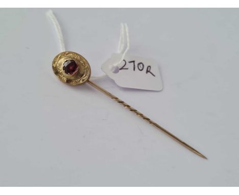 A Georgian almandine garnet stick pin framed and engraved in high carat gold