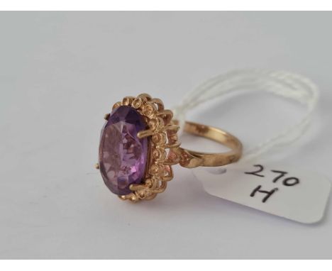 A large fancy amethyst dress ring set in gold