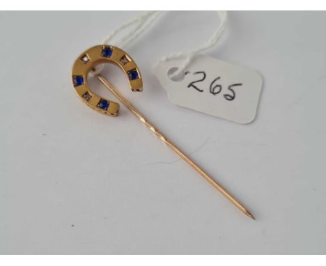 An early Victorian diamond and gemstone high carat horse shoe stick pin 15ct gold