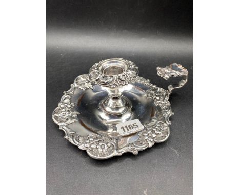 An old Sheffield chamber candlestick with decorated rims
