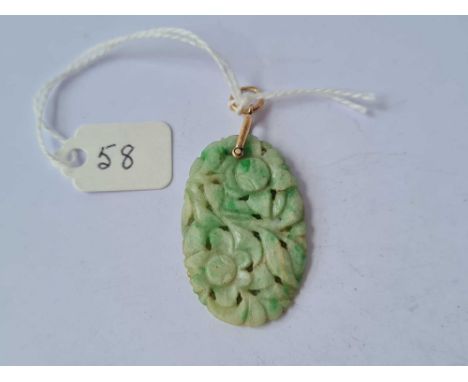 A carved jade and gold pendant