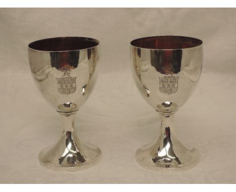 A pair of Georgian silver goblets of plain form having gilt interiors and etched crest and rampant lion to sides, Sheffield 1