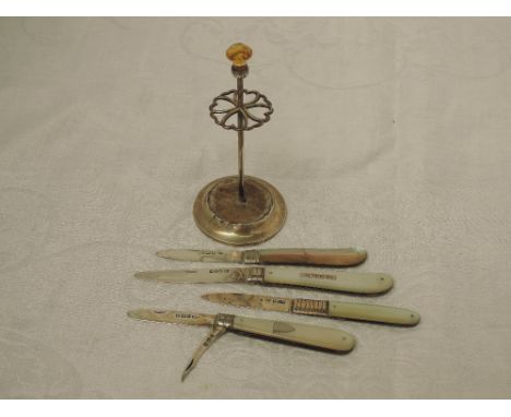 Four folding fruit knives having HM silver blades and mother of pearl handles  (one AF) and an HM silver hatpin stand having 