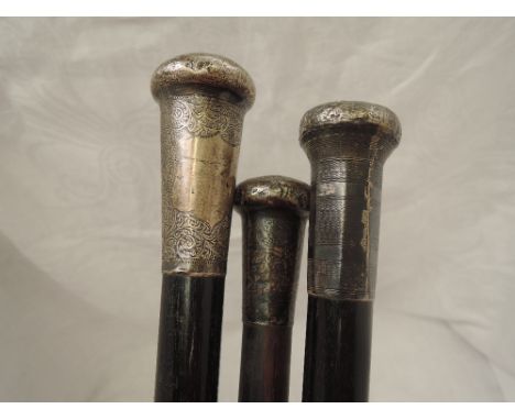 Three gentlemen's walking canes canes having HM silver knops