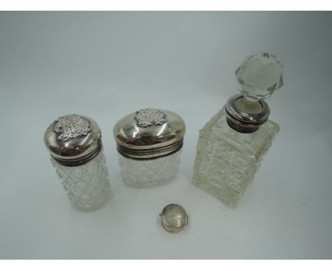 A cut glass dressing table pot having inner hinged silver gilt lid and hinged domed outer silver lid and a matching tubular c