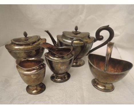 A Dutch silver five piece breakfast tea set of tapered oval form with pineapple finials, wooden swirl handle and pedestal ova