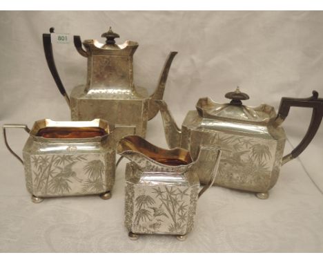 A Victorian Aesthetic movement silver four piece tea service of canted rectangular form having extensive Japanesque engraved 