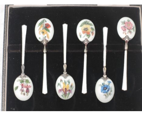 A cased set of six silver and enamel teaspoons having floral pictorial decoration to back of gilt bowls and white enamelled s