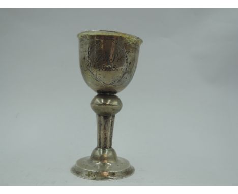 A small Georgian silver Christening goblet of of Ecclesiastical form having monogram dated 1815 and naive engraved flower to 