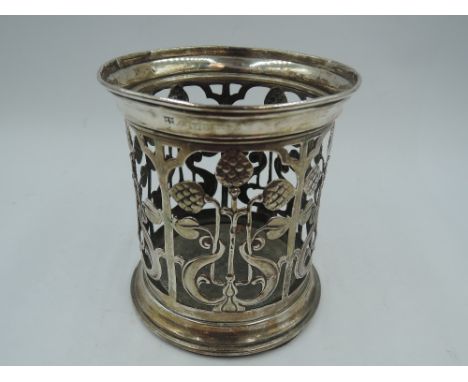 An Edwardian silver bottle/jar holder of cylindrical form (missing glass liner) having Art Nouveau style pierced decoration a