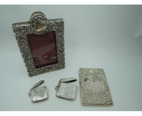 A small Victorian silver overlaid photograph frame having scroll and floral decoration and red leather easel back, Chester 18