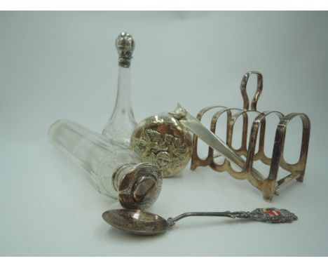 A selection of HM silver and white metal including three glass dressing table pots with silver/white metal lids, a small toas