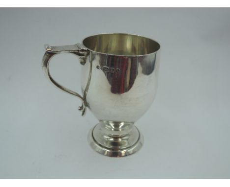 A silver Christening mug of plain stylised form bearing name to front &amp; having angular loop handle, London 1923, Blackmor