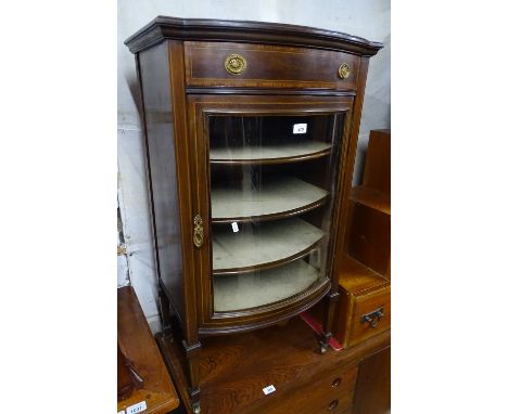 An Edwardian mahogany and satinwood strung music cabinet, of bow-front form, single drawer and glazed cupboard under on squar