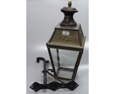 A copper and brass lantern light fitting on metal wall bracket