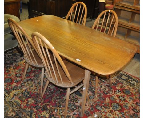 An Ercol Golden Dawn elm rectangular kitchen table on square tapered legs, together with a set of 4 Ercol stick back kitchen 