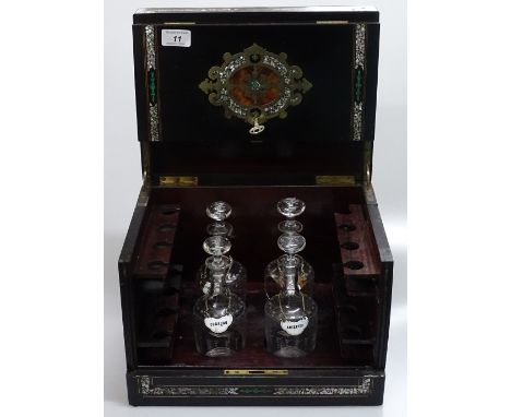 A 19th century Continental brass and mother of pearl marquetry inlaid drinks cabinet, containing 4 original etched glass deca