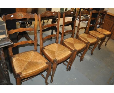 A set of 6 French oak dining chairs, ladder backs, rush seats on cabriole legs