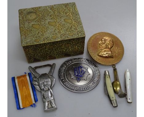 Box containing a German enamel medallion, Winston Churchill bottle opener, penknives etc